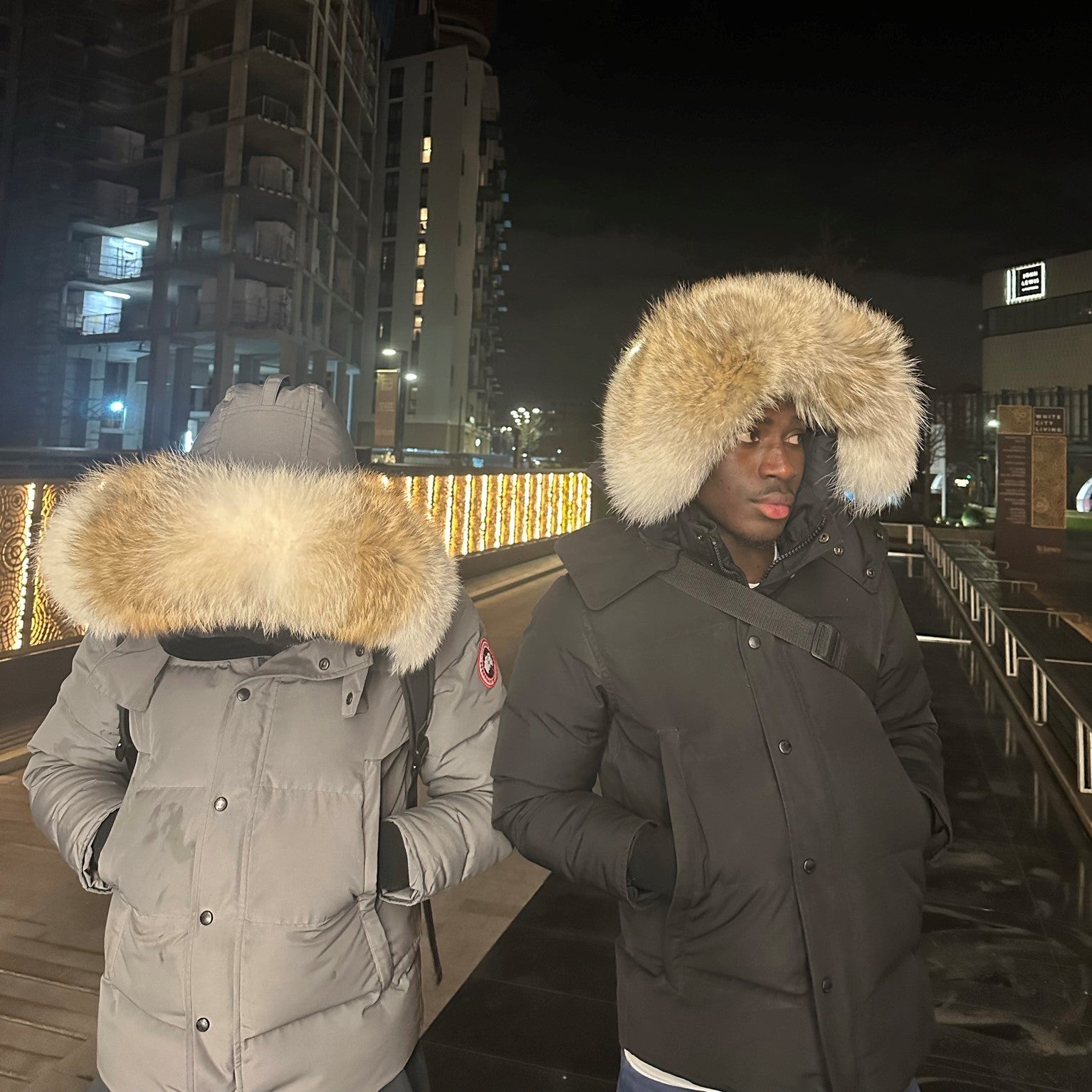 Two men wearing Canada Goose jackets with coyote fur hood replacement trims